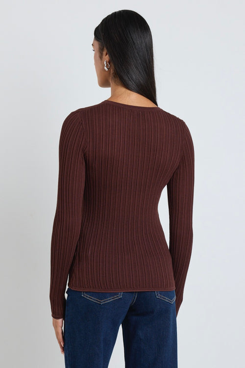 Model wears a brown long sleeve rounded neck ribbed top