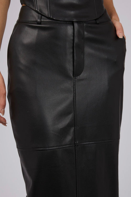 model wears a black leather skirt