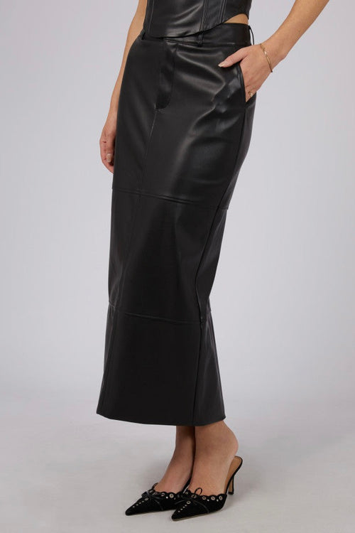 model wears a black leather skirt