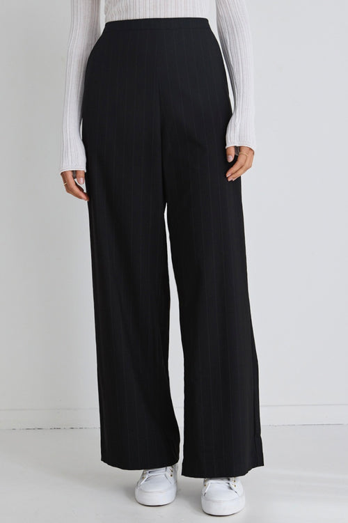 model wears black wide leg pants