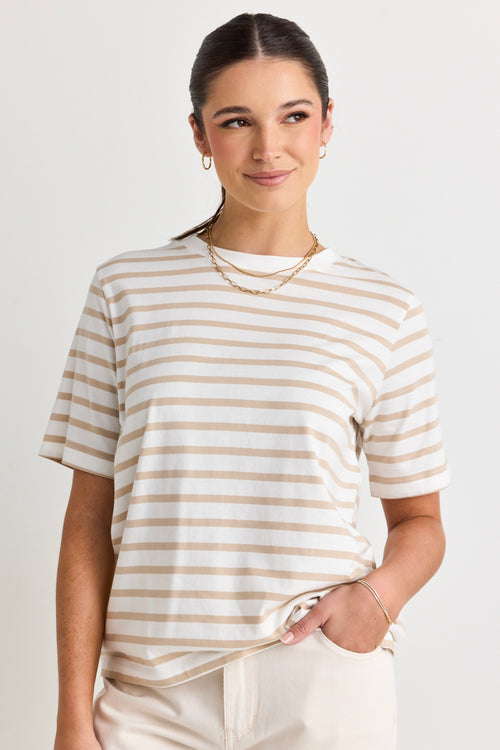 model wears a white and natural stripe tee