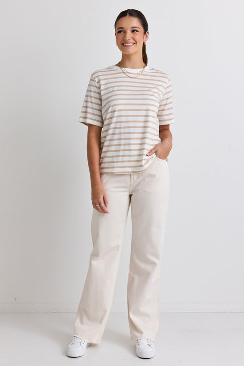 model wears a white and natural stripe tee