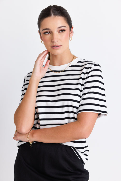 model wears a black and white stripe tee