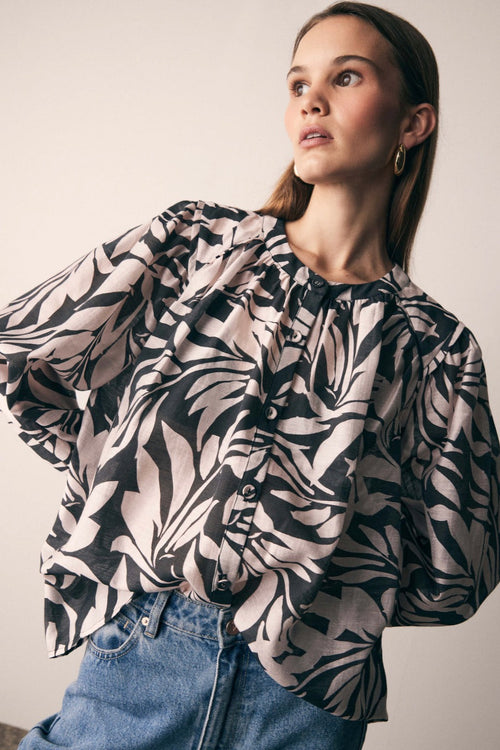 model wears a Black White Print Blouse