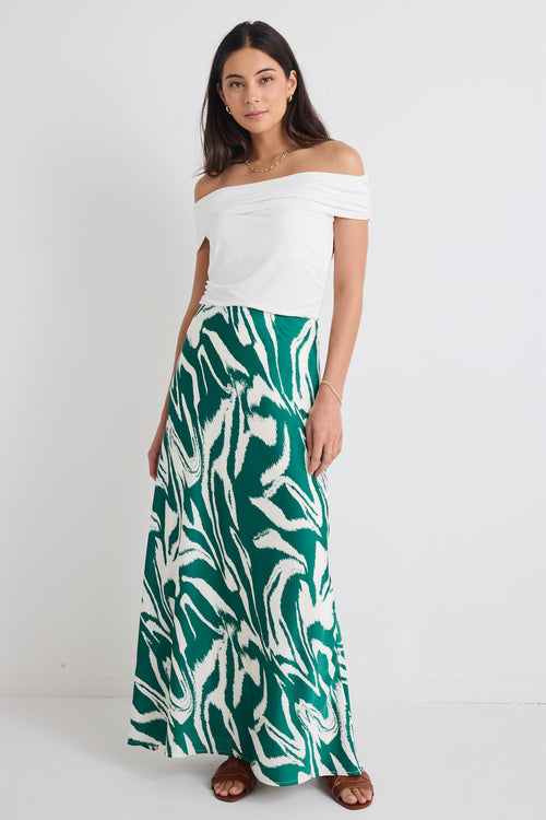 model wears a green print maxi skirt