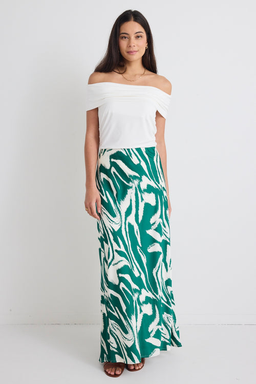 model wears a green print maxi skirt