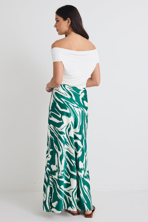 model wears a green print maxi skirt