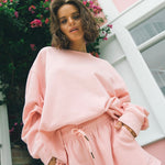 model wears a pink jumper