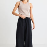 model wears black linen pants