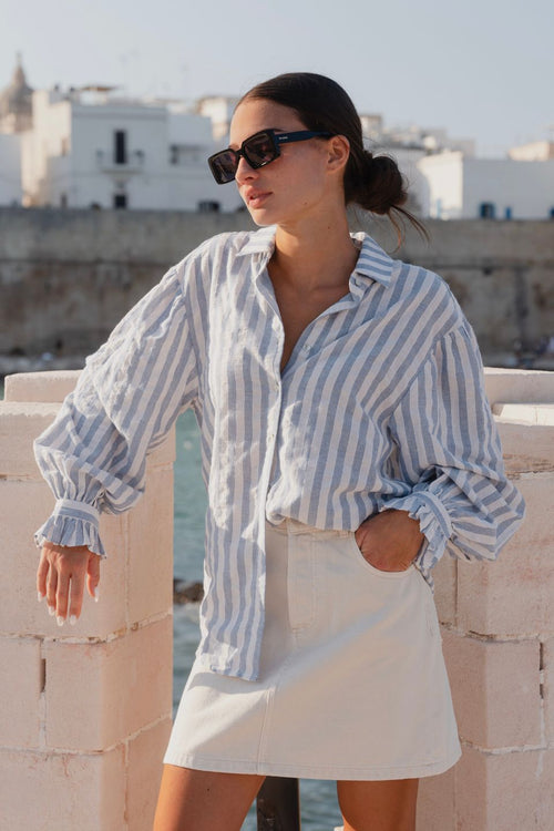 model wears a blue stripe shirt