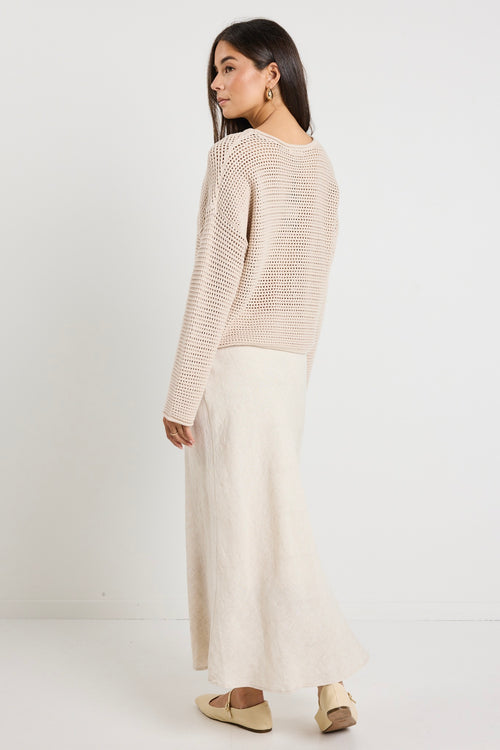 Model wears a crochet beige jumper