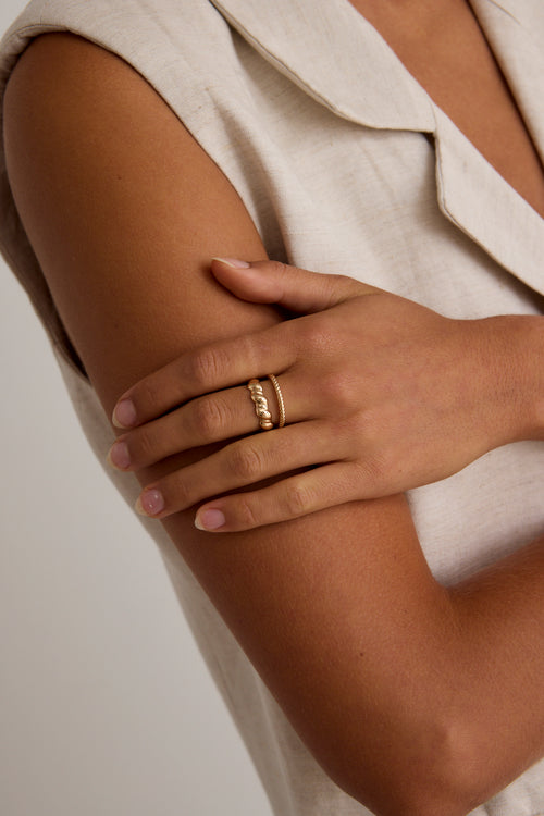 model wears gold rings