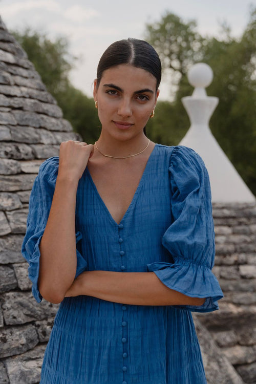 model wears a blue midi dress