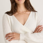 model wears a white knit 