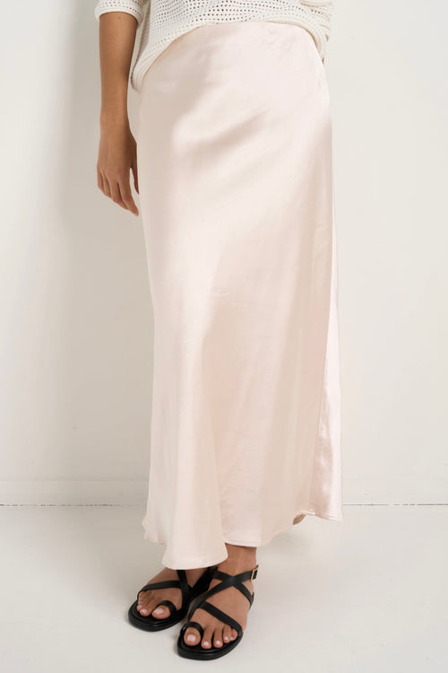 model wears a white silk maxi skirt