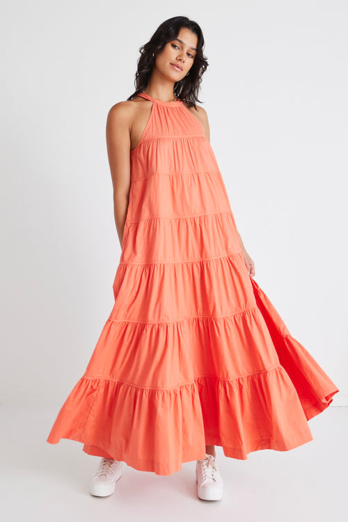 model in orange maxi dress