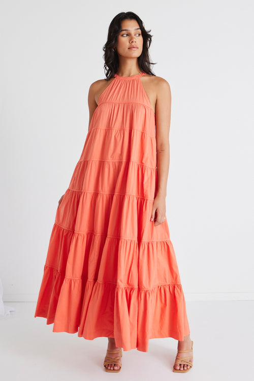 model in orange maxi dress