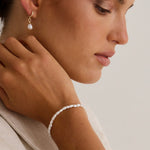 model wears a pearl bracelet