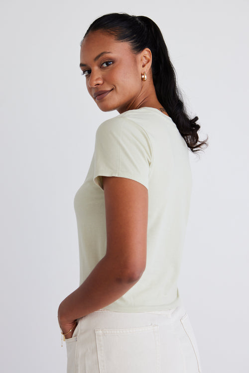 model wears a sage green top