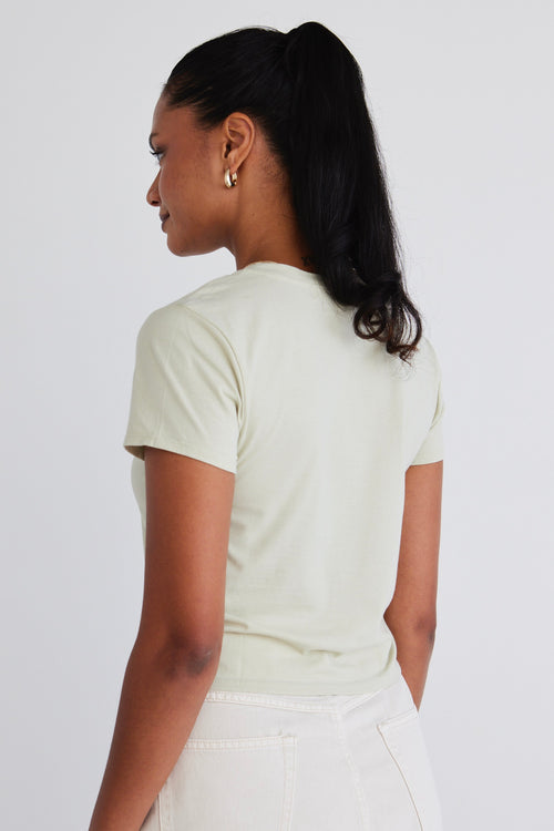 model wears a sage green top