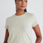 model wears a sage green top