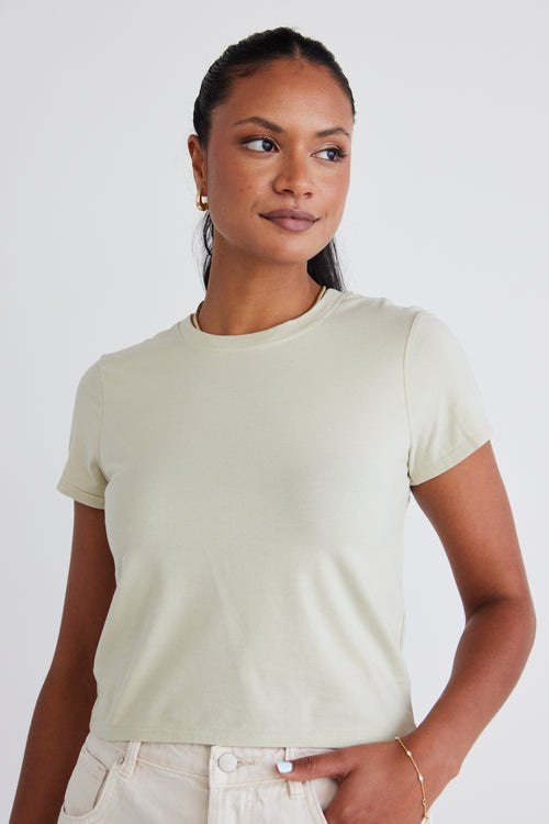 model wears a sage green top