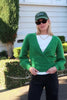 model wears a green knit