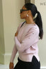 Model wears a pink batwing jumper