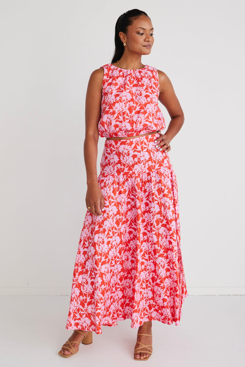 model wears a pink floral crop top with pink floral skirt