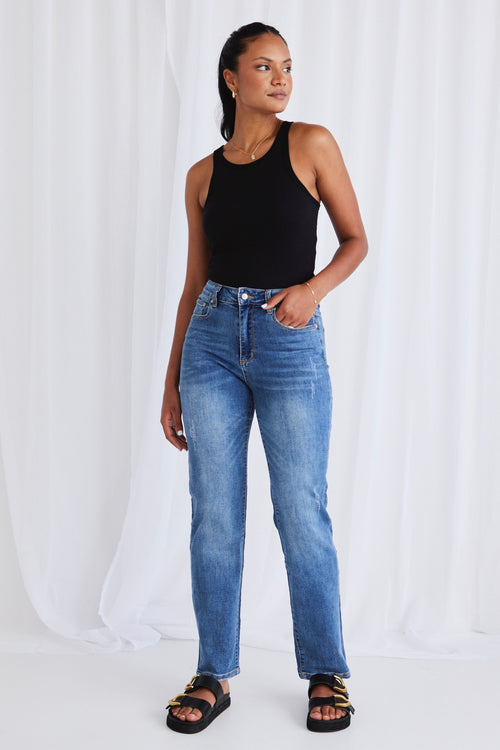 model wears dark blue jeans 