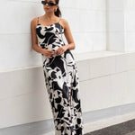 model wears a black and white maxi dress