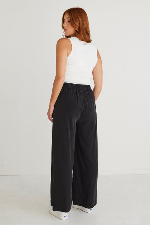 model wears black wide leg pants