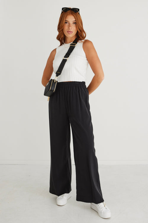 model wears black wide leg pants