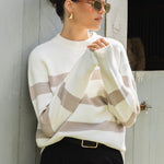 model wears a stripe knit with black pants