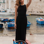 model wears black rib knit maxi dress outside on a boat