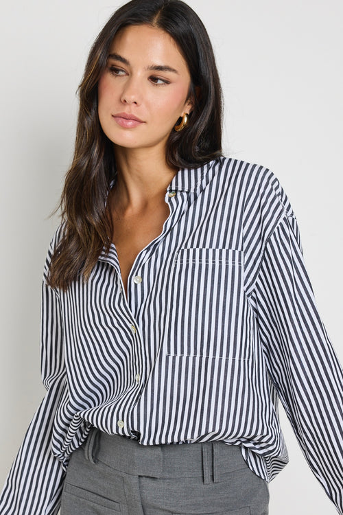 model wears a black and white stripe shirt